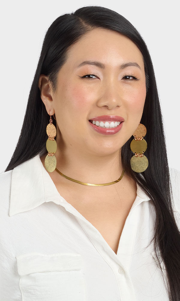 Model wearing metalworking earrings